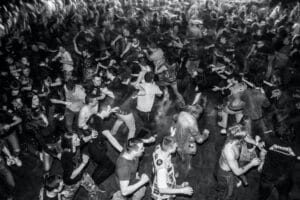 black and white photo of a circle pit at a concert