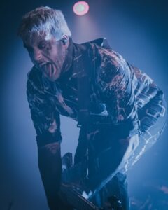 Motionless In White on stage performing on their Trinity of Horror tour.